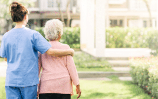a caregiver hugging a senior lady