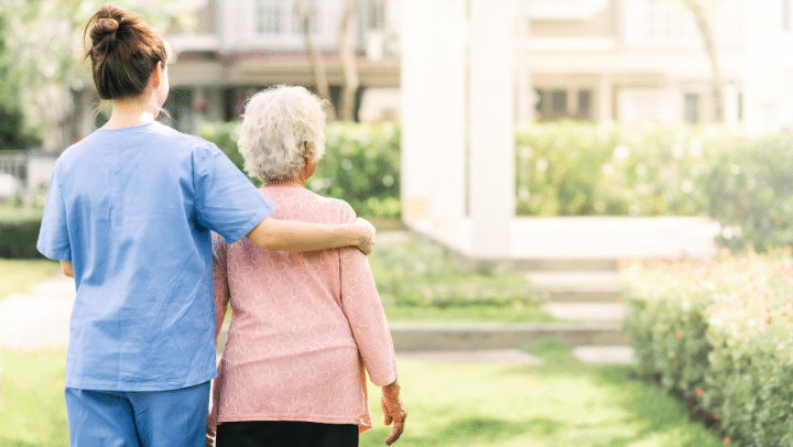 a caregiver hugging a senior lady