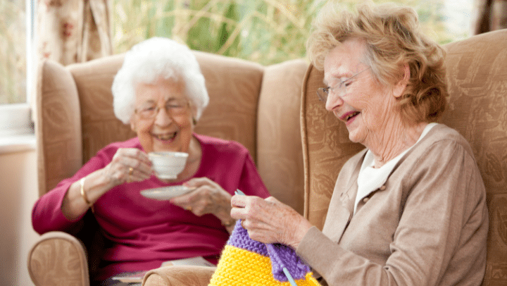 two senior ladies laughing together 