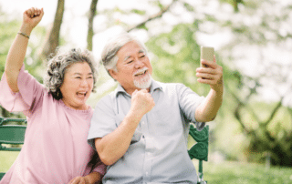 an elderly couple making a video call from their cell phone