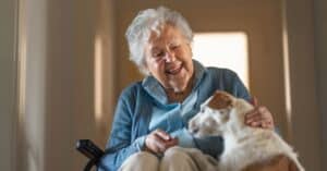 older woman and pet in dementia care community