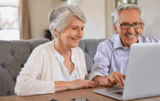 an elderly couple on a video call with their family