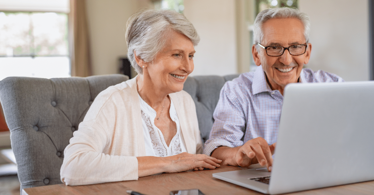 an elderly couple on a video call with their family